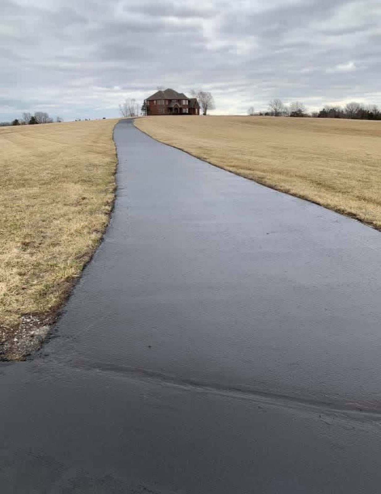 Long rural asphalt lane after sealcoating