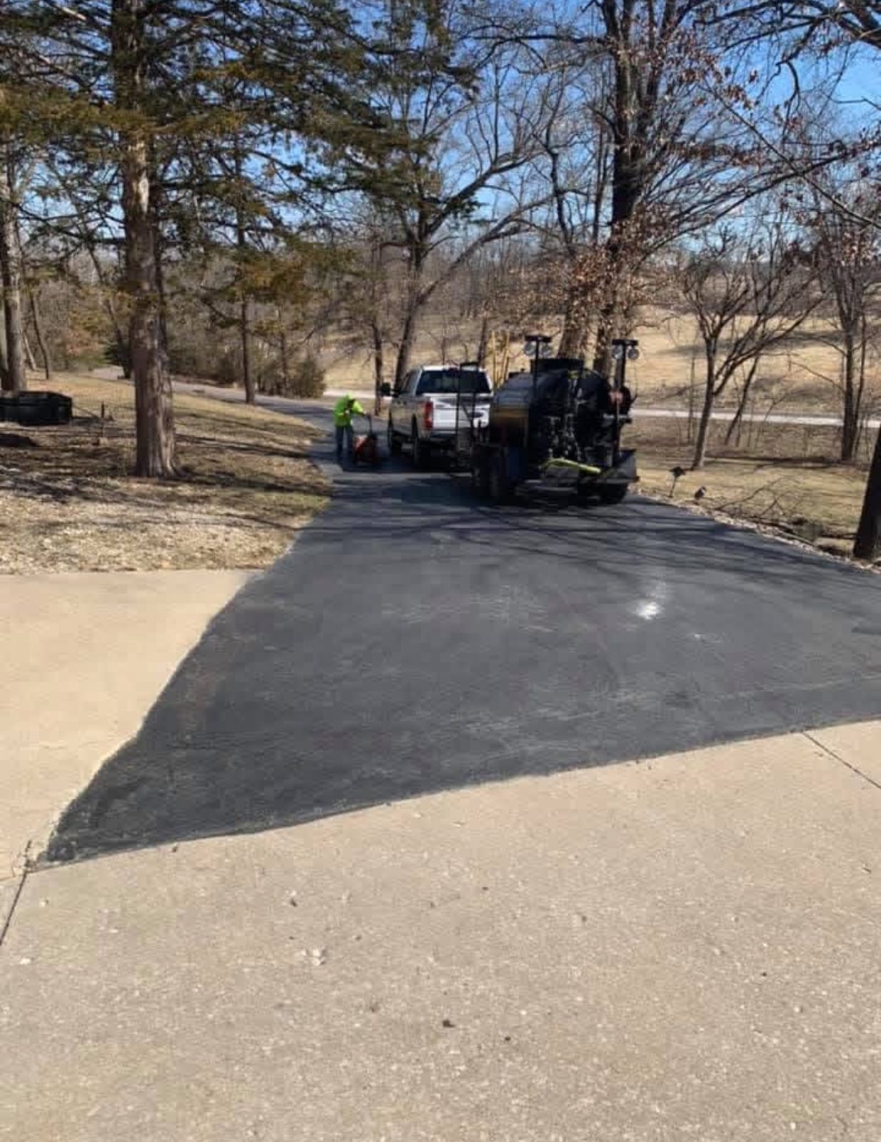 Sealcoating crew truck on drive by United Way Asphalt