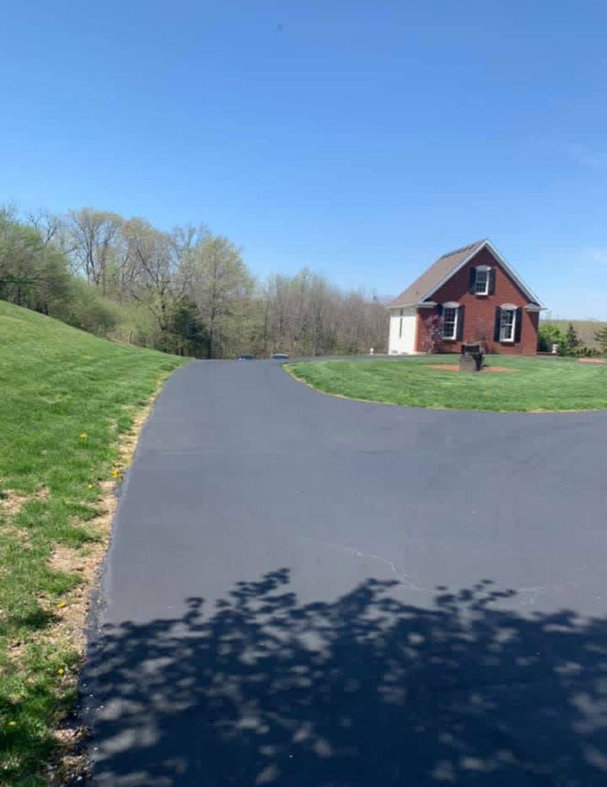 Sealcoating brick home driveway by United Way Asphalt