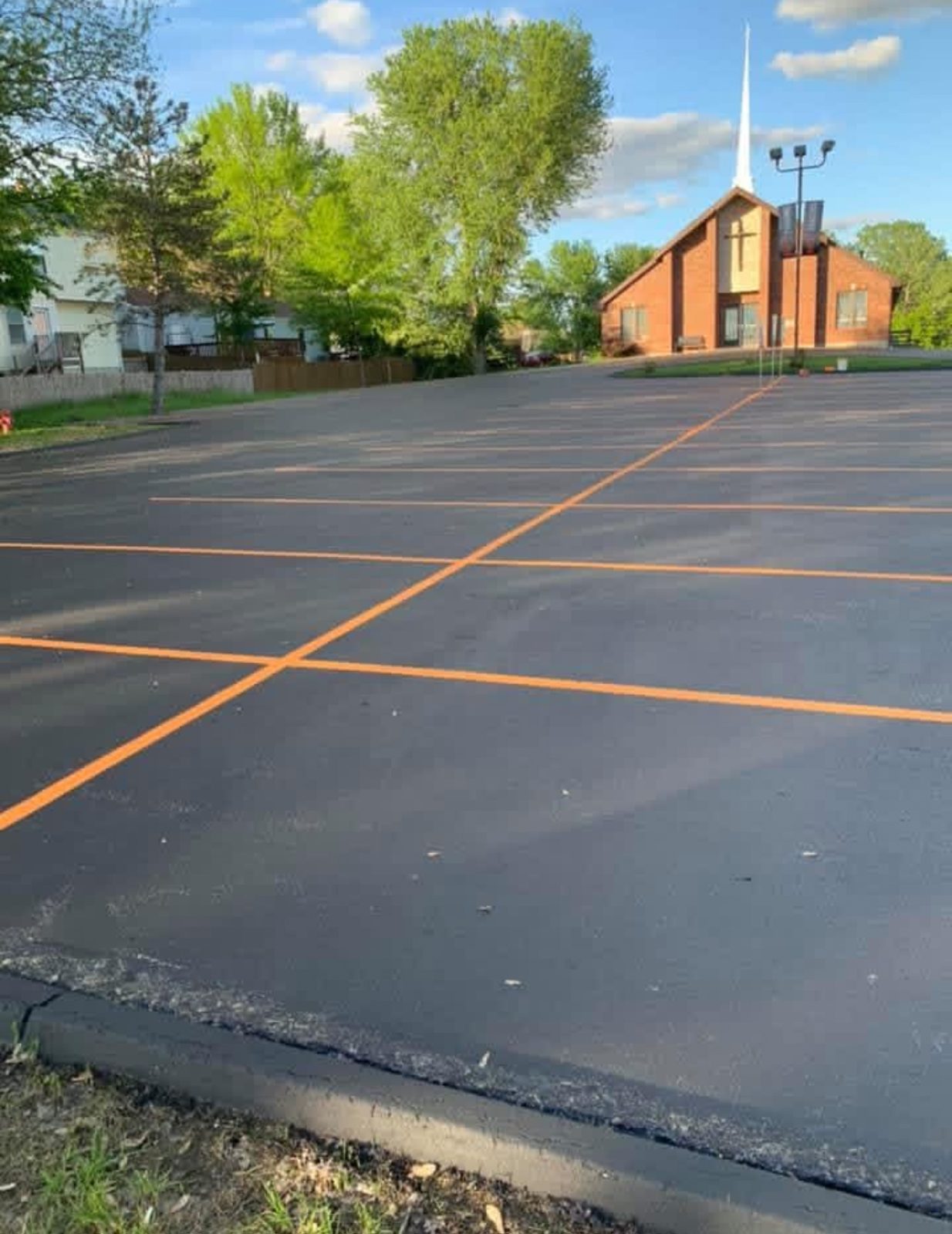 Striping orange stall lines by United Way Asphalt