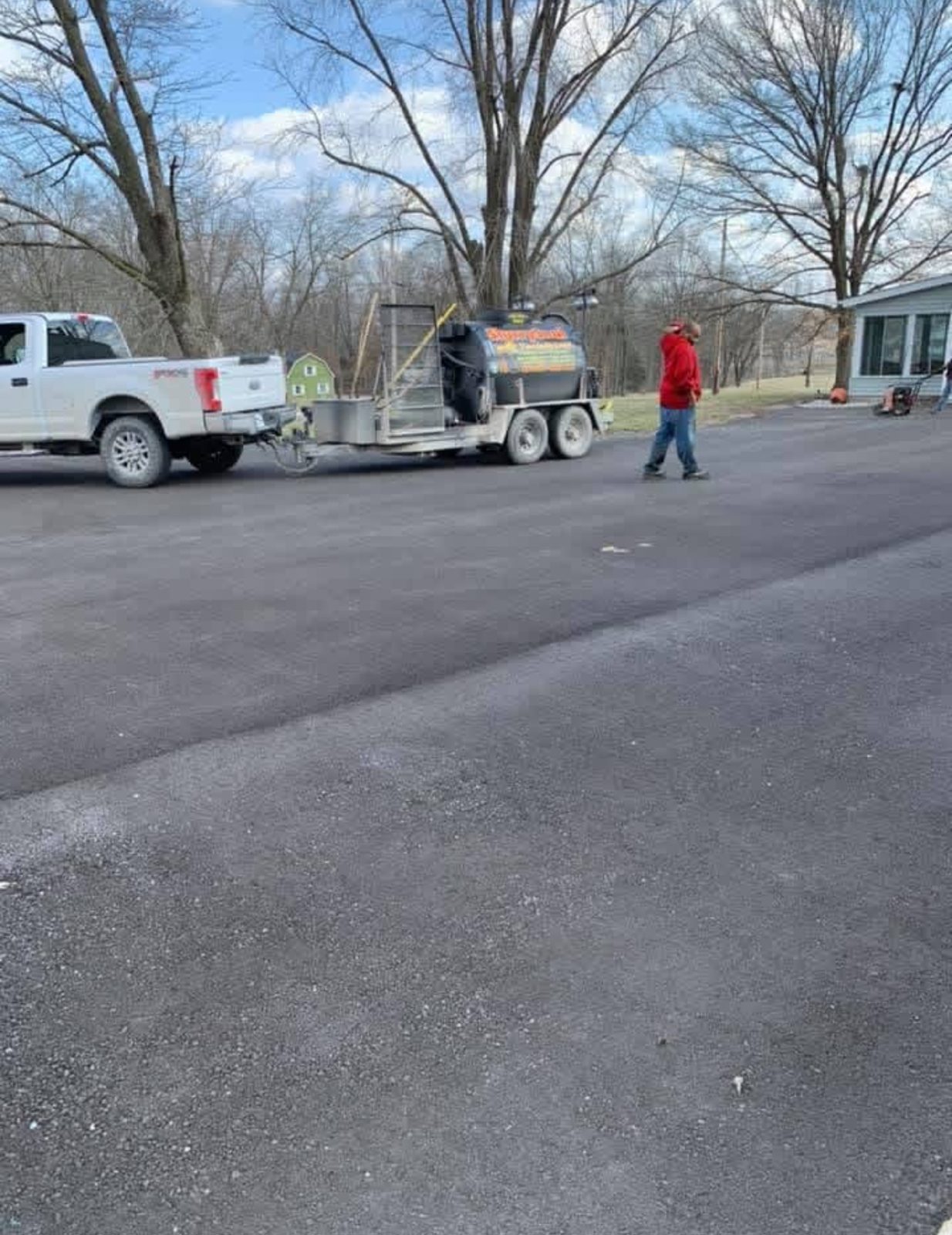 United Way Asphalt sealcoating equipment on a driveway jobsite