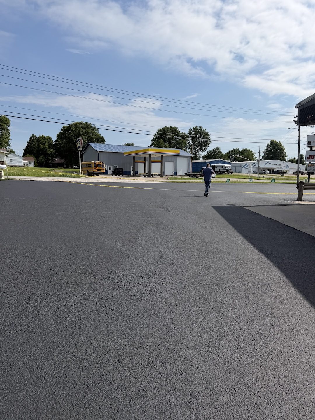 Convenience store lot with a freshly paved asphalt surface