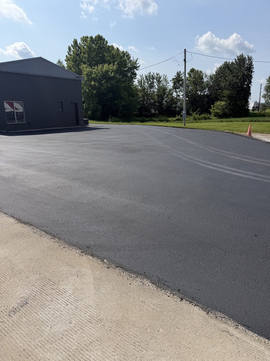 Paving commercial lot metal building by United Way Asphalt