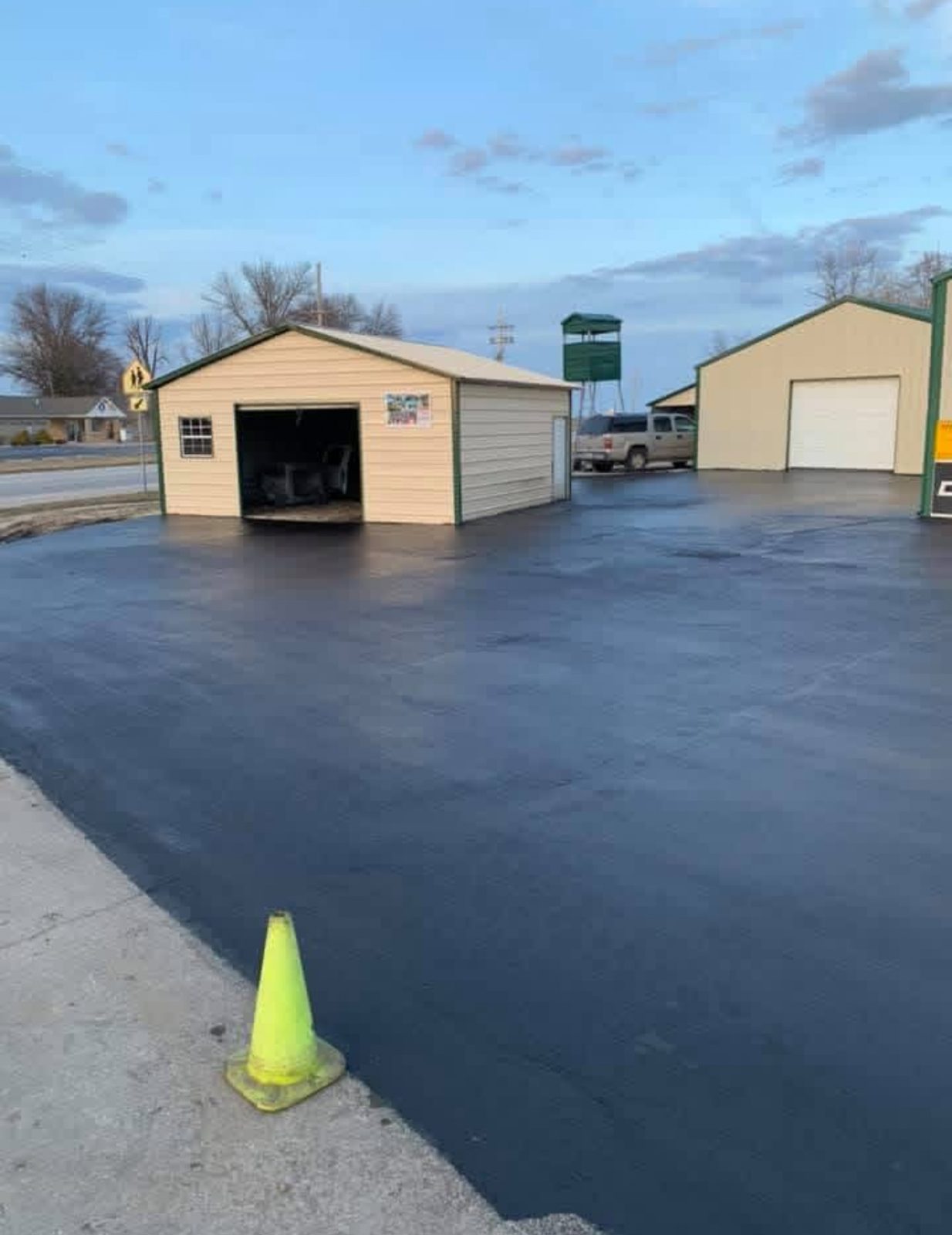 Commercial shop lot after sealcoating with a uniform black finish